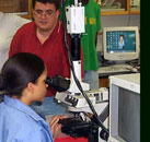 Students views paddlefish under microscope